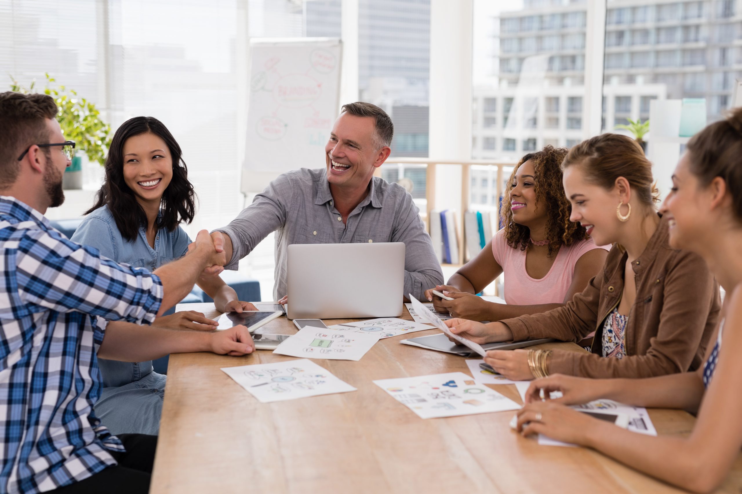 Executives shaking hands in the meeting after having the best B2B loyalty program